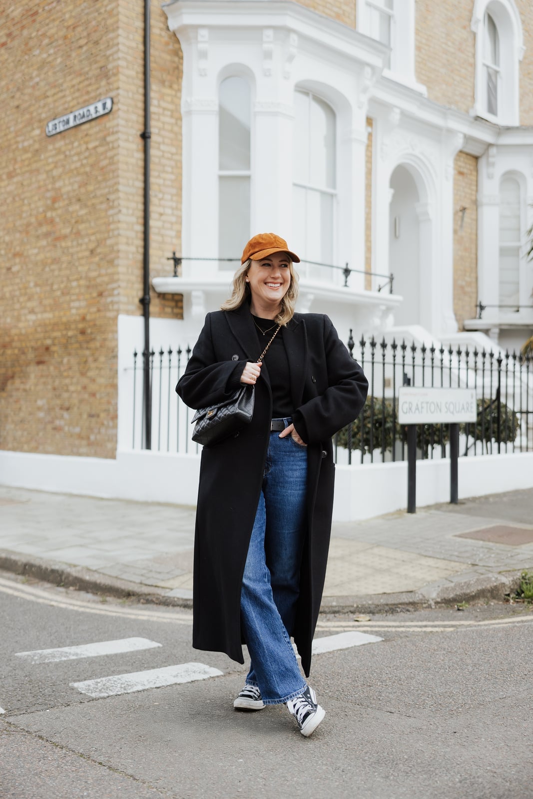 Long Black Coat with Orange Cap and Sneakers Long Black Coat with Orange Cap and Sneakers — Trendy Casual Dinner Outfit
