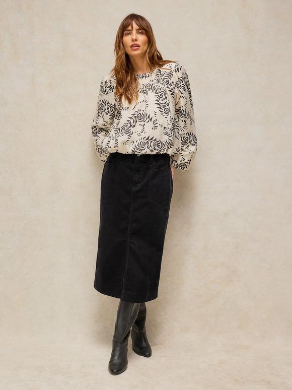 Black Corduroy Midi Skirt with Patterned Top and Knee-High Boots — Trendy Corduroy Skirt Outfit