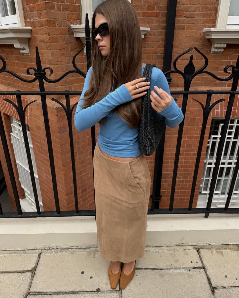 Long Tan Suede Skirt with Light Blue Top and Black Woven Handbag — Trendy Corduroy Skirt Outfit