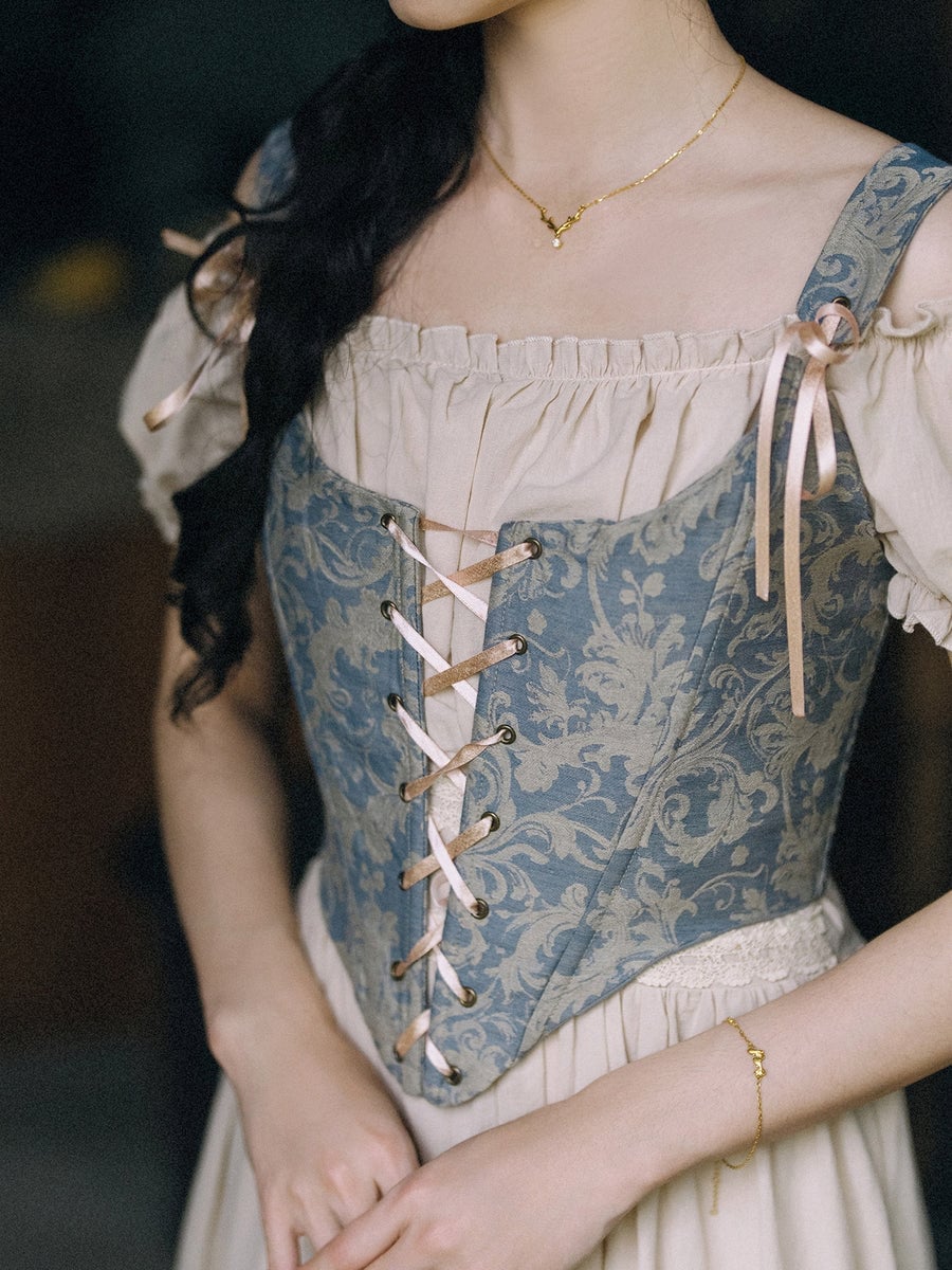 Blue Brocade Corset with Lace-Up Detail Over Cream Blouse Blue Brocade Corset with Lace-Up Detail Over Cream Blouse — Trendy Cottagecore Outfits