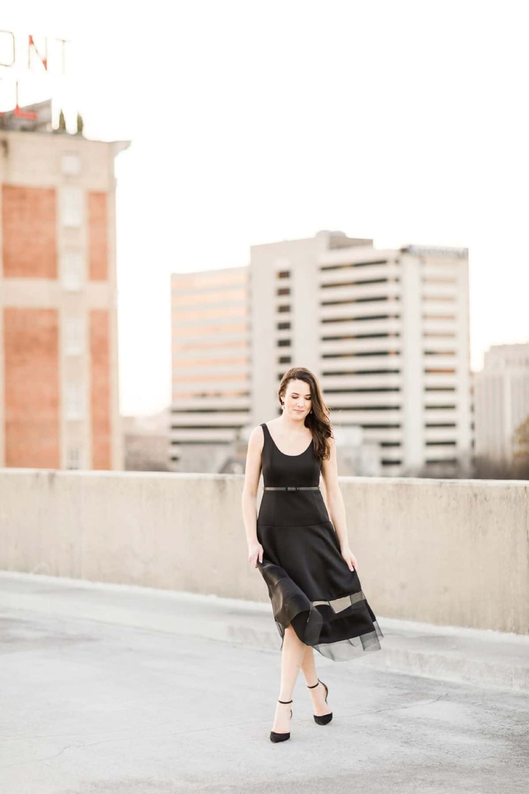 Black Sleeveless Dress with Sheer Hem and Paired With Strappy Heels Black Sleeveless Dress with Sheer Hem and Paired With Strappy Heels — Trendy Engagement Photos Outfits