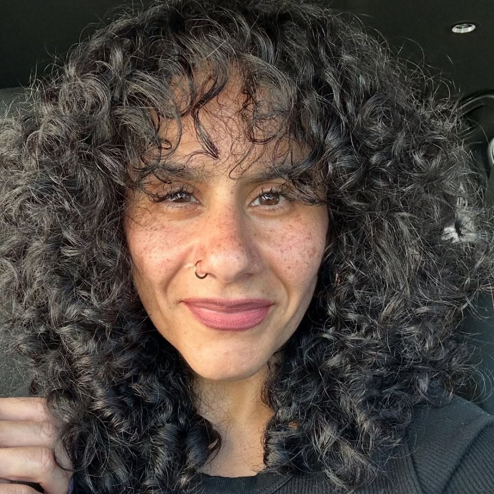 Chin-Length Dark Curly Bob With Subtle Highlights — Trendy Frizzy Hair