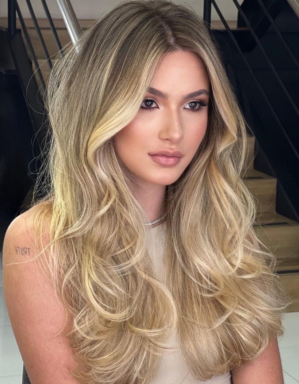 Mid-Back Ash and Golden Blonde Highlights With Curtain Bangs — Trendy Golden Blonde