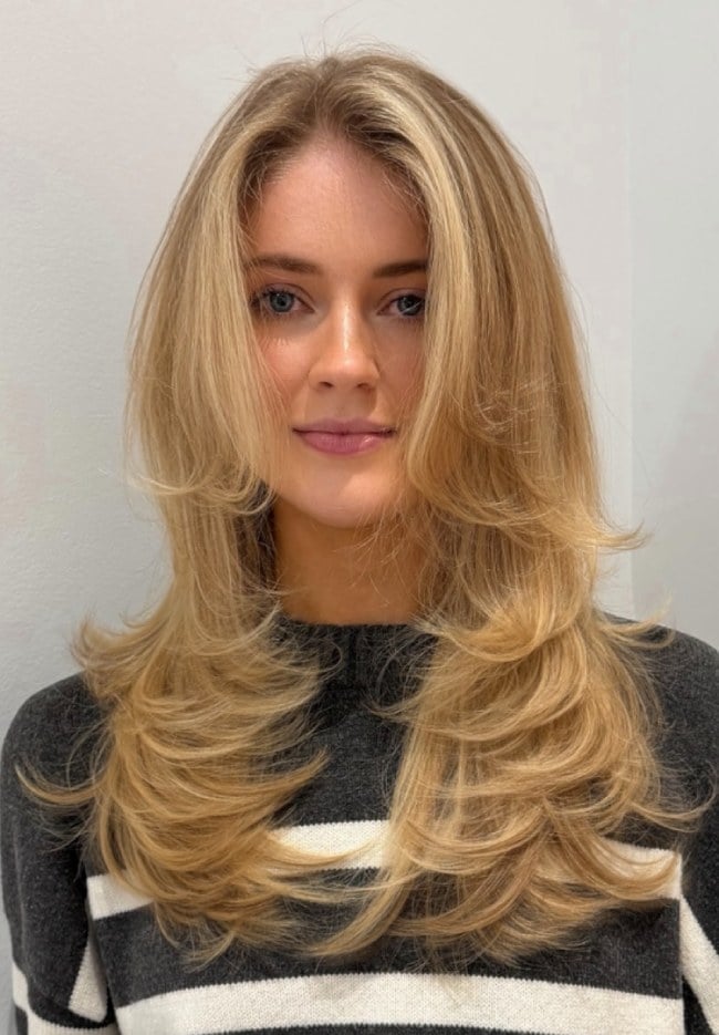 Mid-Back Golden Blonde With Curtain Bangs and Blowout With Soft Waves — Trendy Golden Blonde