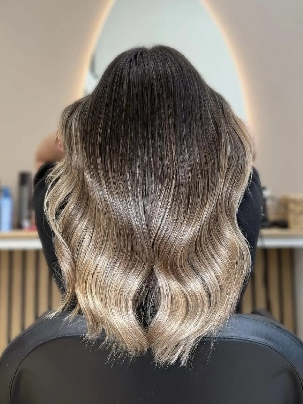 Mid-Back Layers With Dark To Blonde Balayage and Wavy Blowout — Trendy Hair Care Routine