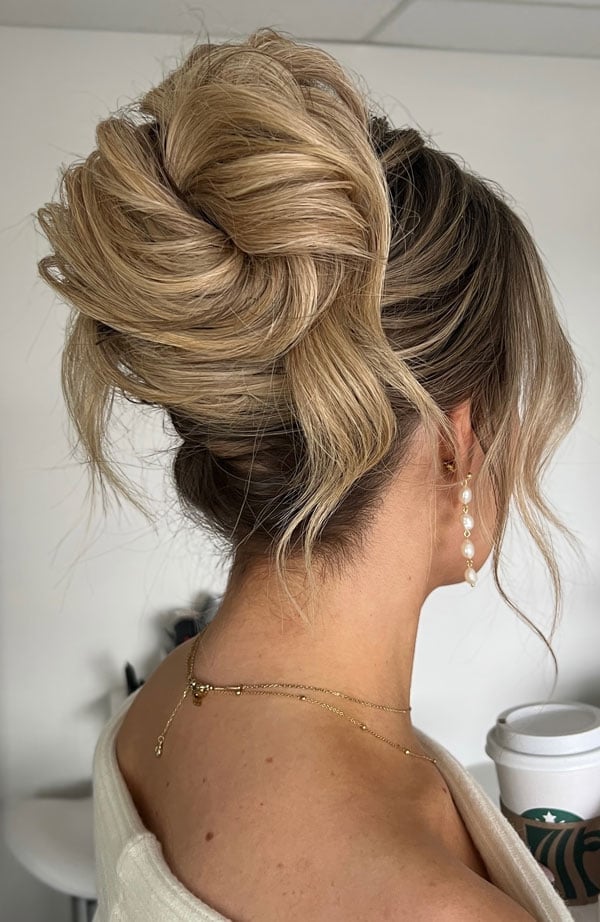 Voluminous Textured High Bun Blonde Highlights, Close-Up Take Voluminous Textured High Bun Blonde Highlights, Close-Up Take — Trendy High Bun Hairstyles