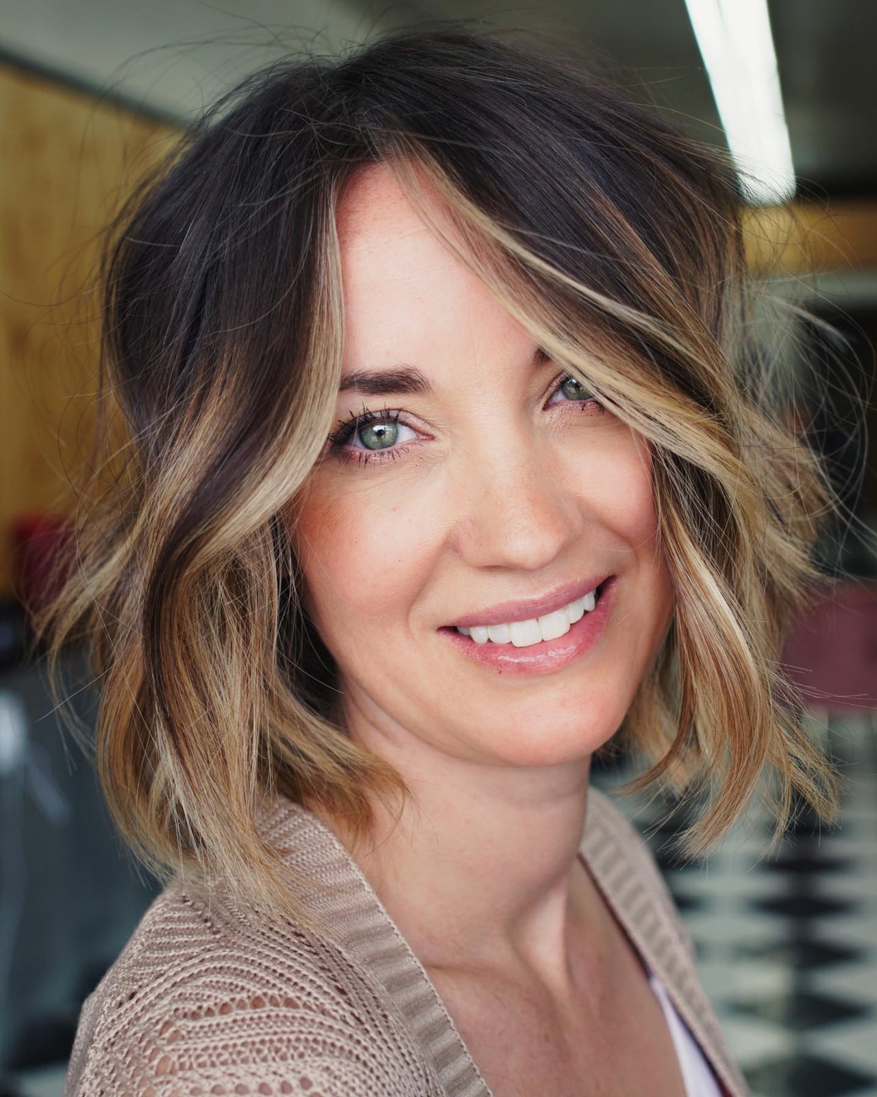 Chin-Length Bob With Wispy Bangs and Blonde Highlights — Trendy Highlights Hair