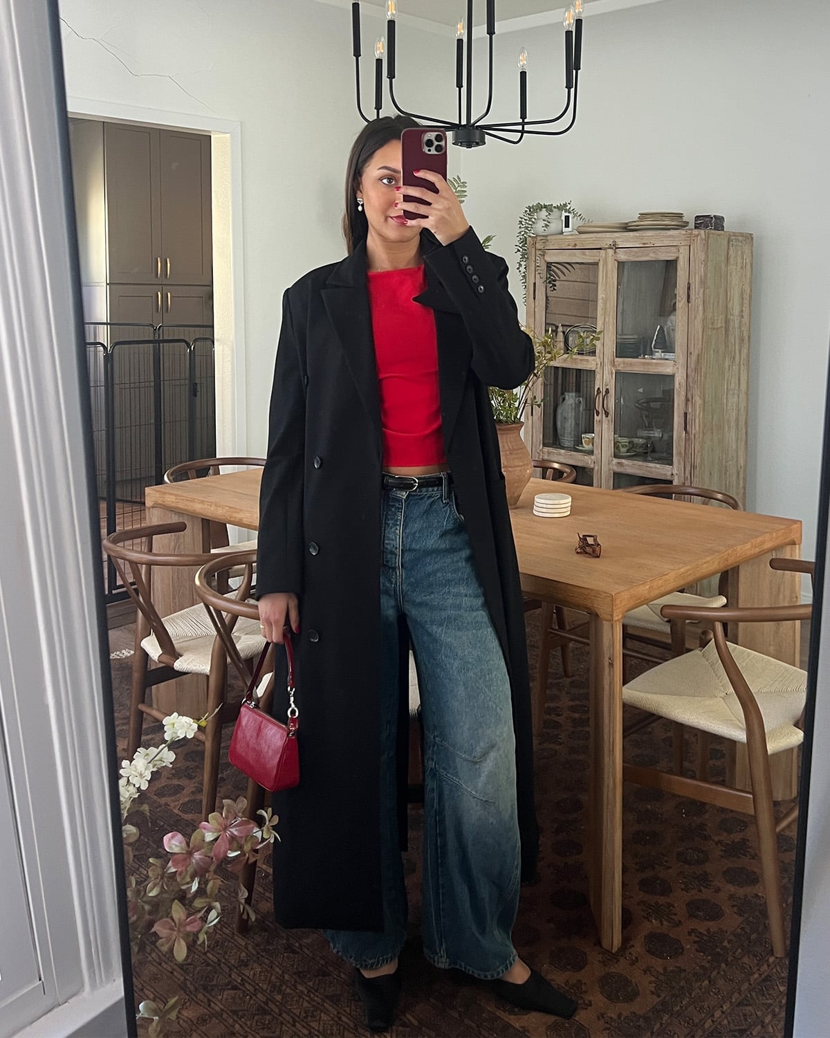 Long Black Coat Over Red Crop Top And Wide Leg Jeans Long Black Coat Over Red Crop Top And Wide Leg Jeans — Trendy Los Angeles Outfits