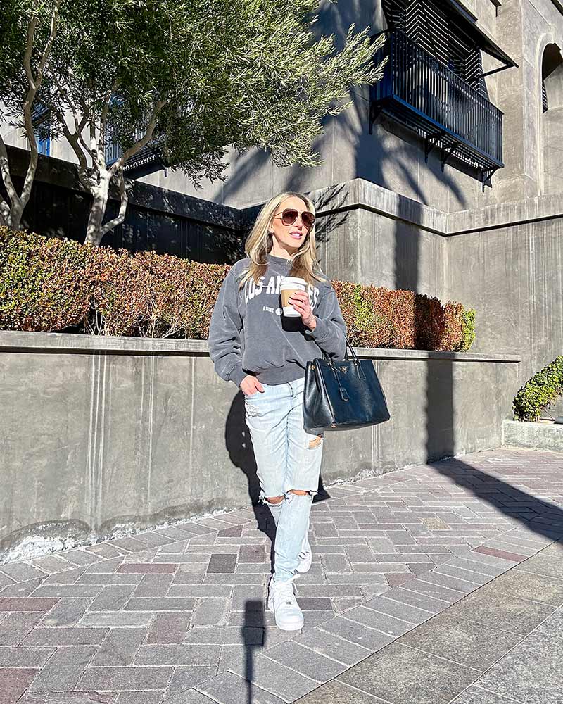 Gray LA Graphic Sweatshirt With Ripped Jeans, Close-Up Take Gray LA Graphic Sweatshirt With Ripped Jeans, Close-Up Take — Trendy Los Angeles Outfits