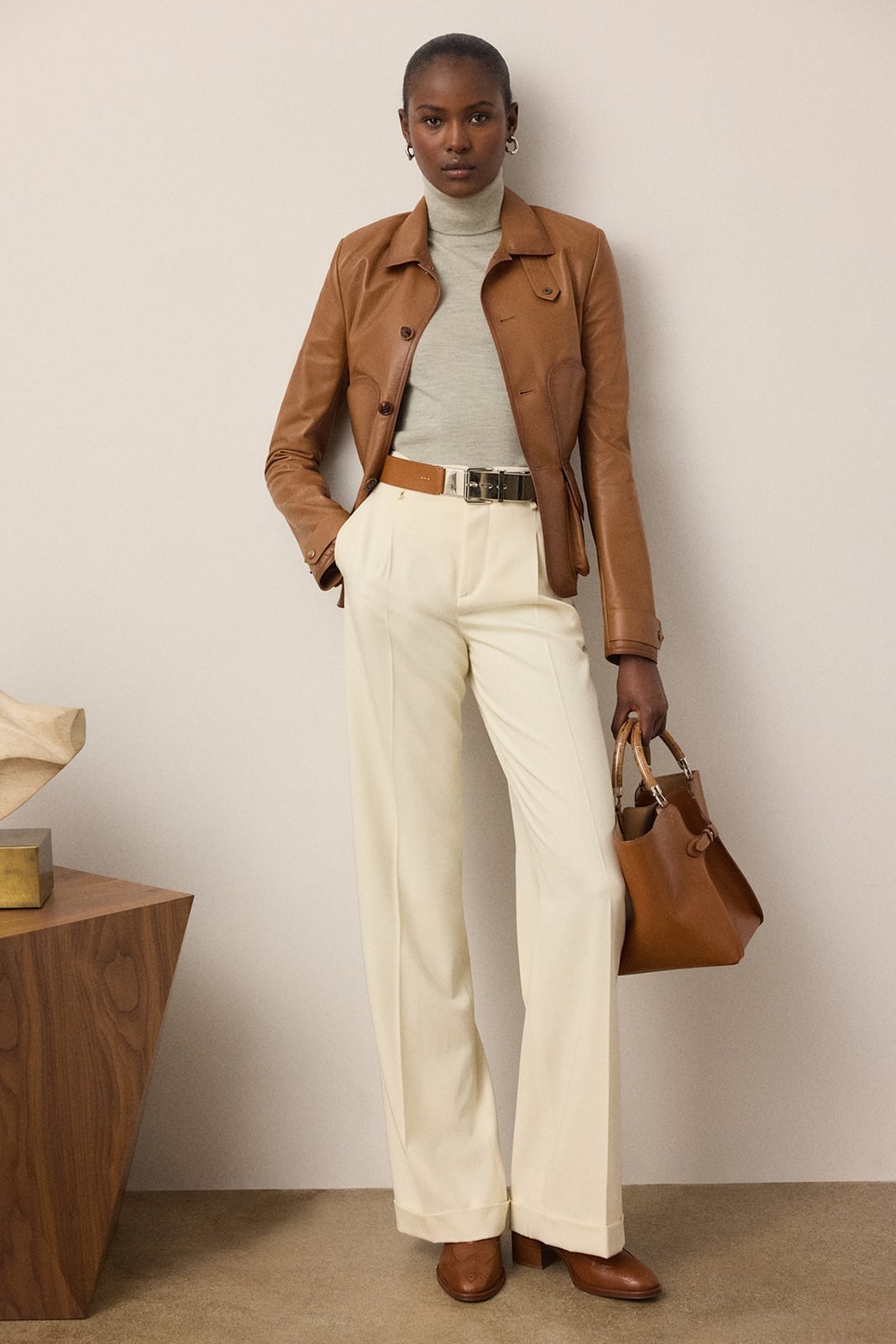 Brown Leather Jacket With Gray Turtleneck And Cream Trousers Brown Leather Jacket With Gray Turtleneck And Cream Trousers — Trendy Luxury Outfits