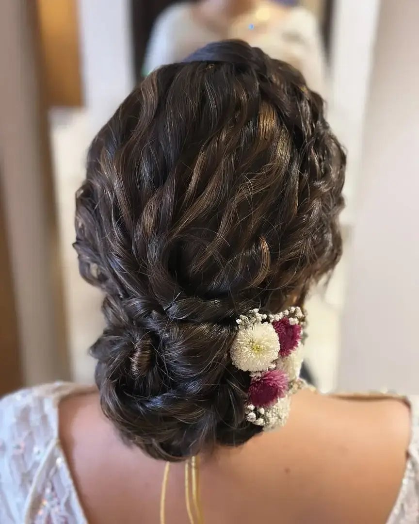 Dark Brown Messy Bun With Braids and Flowers — Trendy Messy Bun Updo