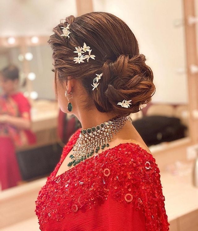 Braided Bun With Floral Accents Braided Bun With Floral Accents — Trendy Party Hair