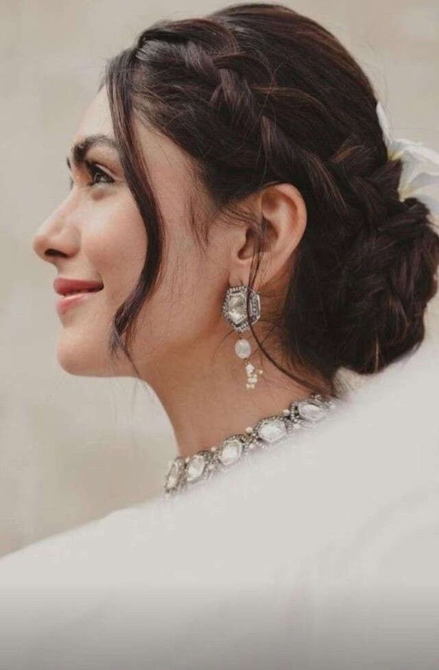 Braided Bun With Loose Tendrils Braided Bun With Loose Tendrils — Trendy Party Hair