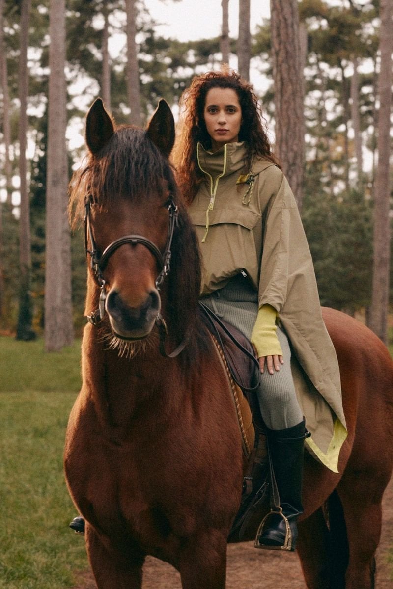 Khaki Poncho with Neon Trim Over Knitwear and Black Riding Boots Khaki Poncho with Neon Trim Over Knitwear and Black Riding Boots — Trendy Ralph Lauren Outfits