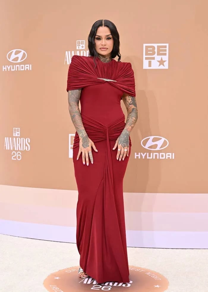 Deep Red Gown With Ruched Bodice And Draped Shoulder — Trendy Red Carpet Outfits