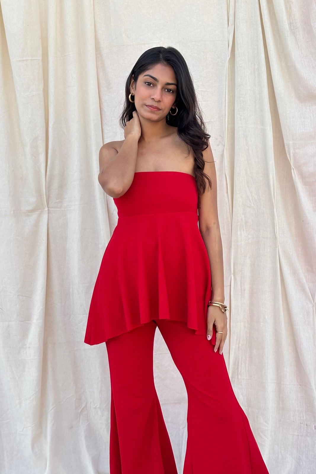Vibrant Red Strapless Peplum Top with Flared Trousers, Close-Up Take Vibrant Red Strapless Peplum Top with Flared Trousers, Close-Up Take — Trendy Red Top Outfits