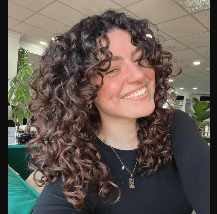 Collarbone Defined Curls With Curtain Bangs — Trendy Shoulder Length Curly Hair