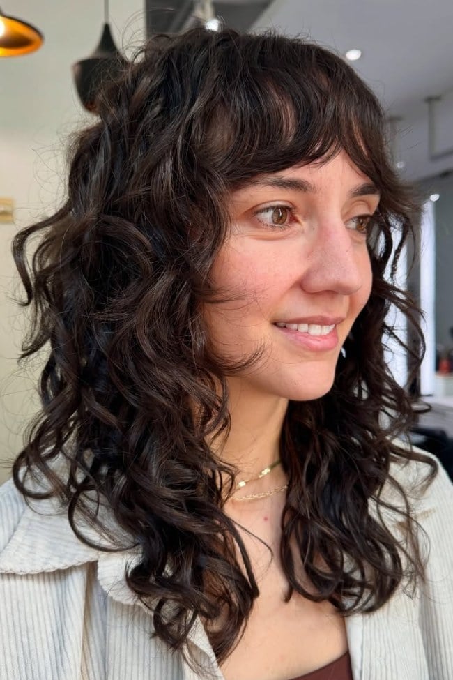 Collarbone Shag With Soft Curtain Bangs — Trendy Shoulder Length Curly Hair