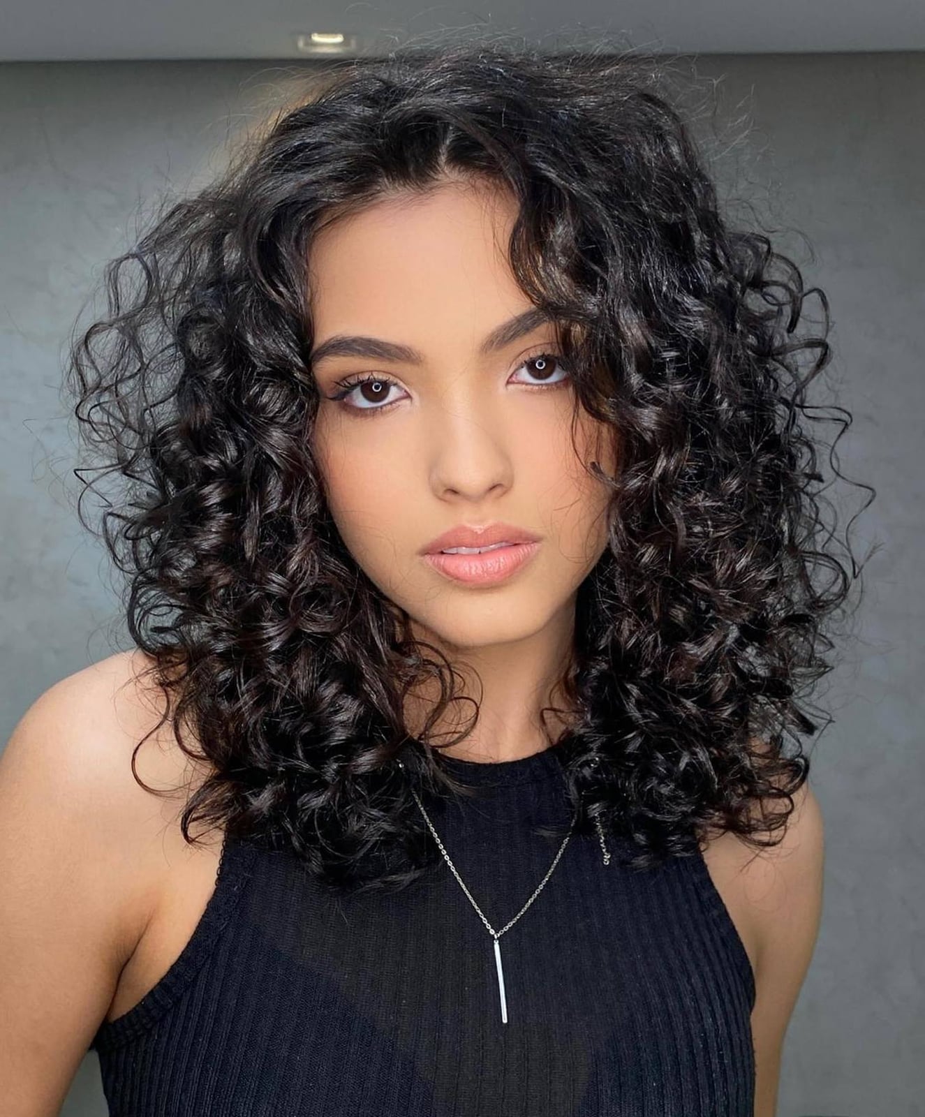 Collarbone Length Waves With Subtle Highlights — Trendy Shoulder Length Curly Hair