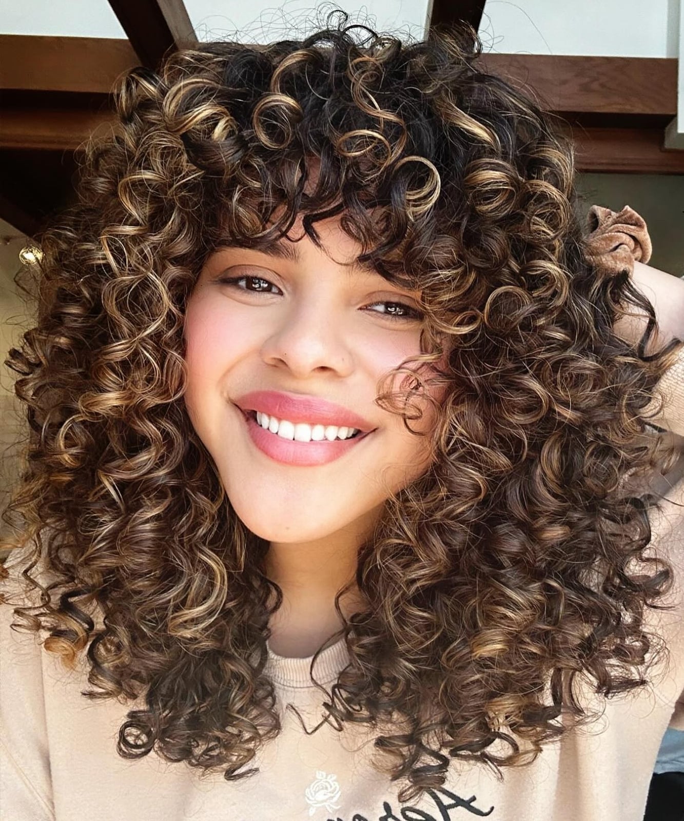 Dark Brown Curls With Blonde Dimensional Highlights — Trendy Shoulder Length Curly Hair