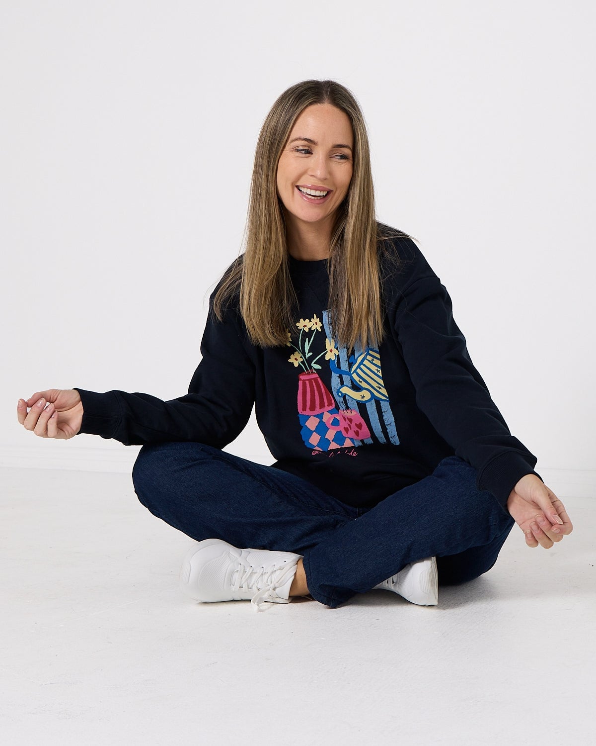 Navy Sweatshirt with Colorful Graphic and Jeans — Trendy Sweatshirt Outfits Women