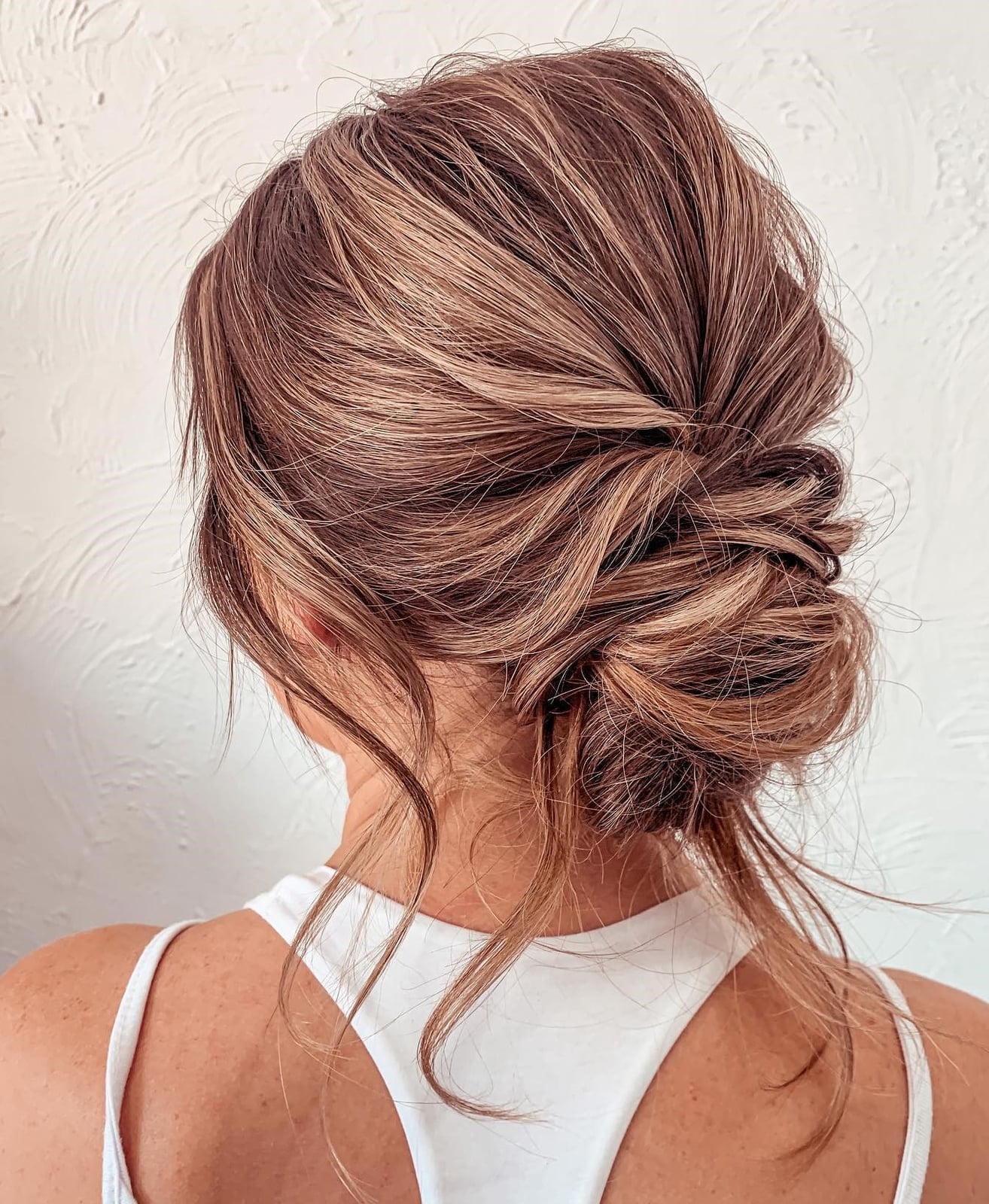Blonde Messy Updo With Loose Waves — Trendy Wedding Guest Updos