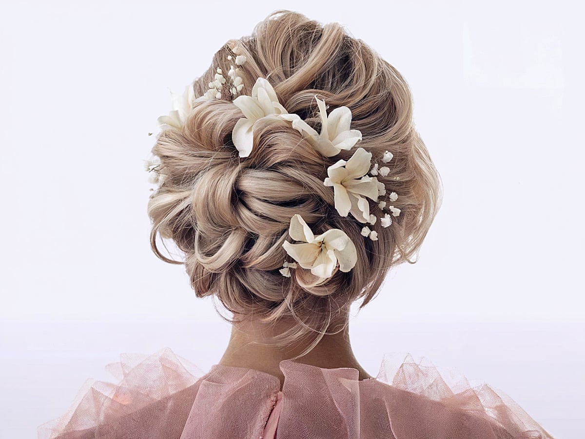 Ash Blonde Updo With Floral Accents — Trendy Wedding Guest Updos