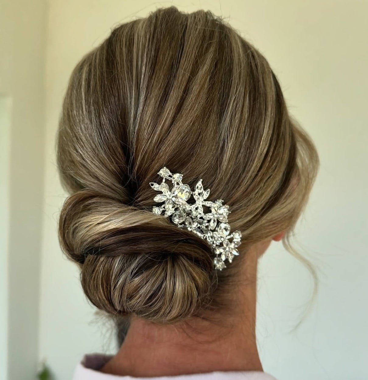 Dark Blonde Low Bun With Accessory — Trendy Wedding Guest Updos