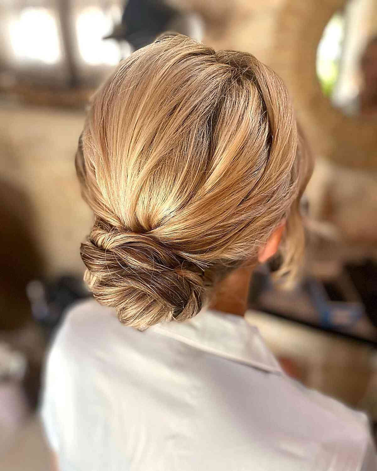 Blonde Low Bun With Darker Roots — Trendy Wedding Guest Updos