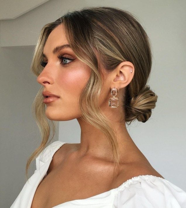 Blonde Low Bun With Loose Waves — Trendy Wedding Guest Updos