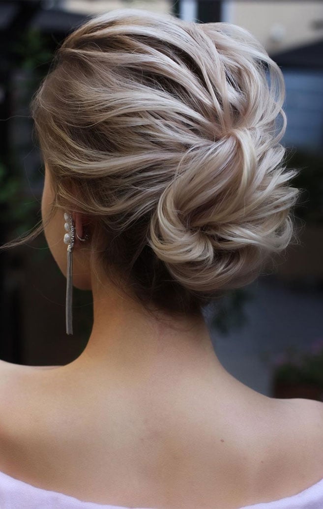 Platinum Blonde Messy Bun With Texture — Trendy Wedding Guest Updos