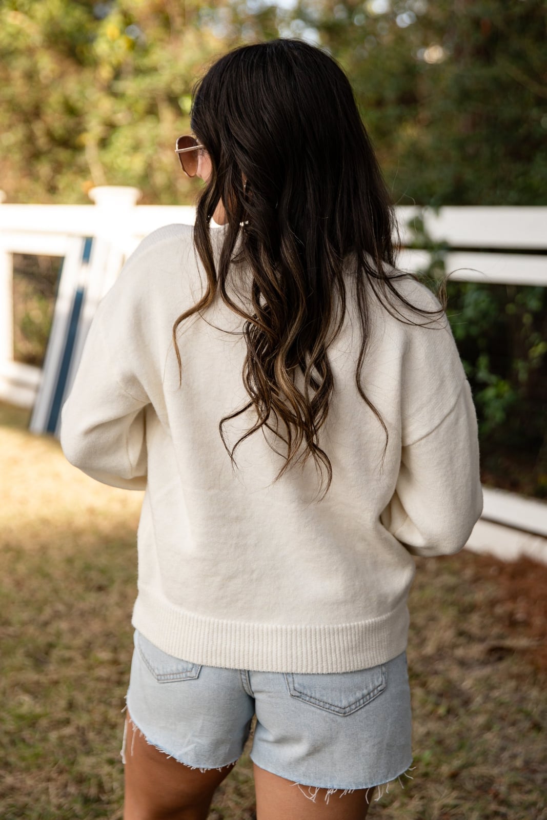 White Relaxed Fit Sweater With Red Script Detail White Relaxed Fit Sweater With Red Script Detail — Trendy White Sweater Outfit