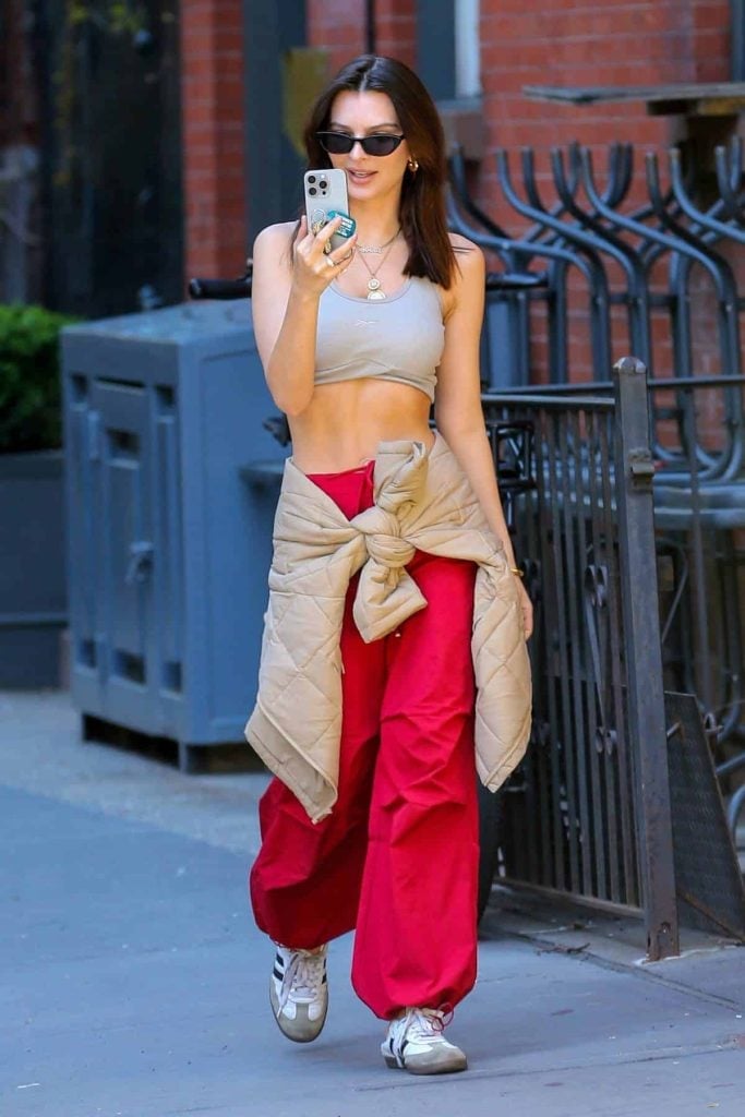 Beige Quilted Jacket Tied Around Waist with Red Pants — Trendy Windbreaker Outfits