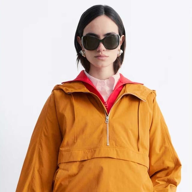 Orange Hooded Windbreaker with Pink Collared Shirt — Trendy Windbreaker Outfits