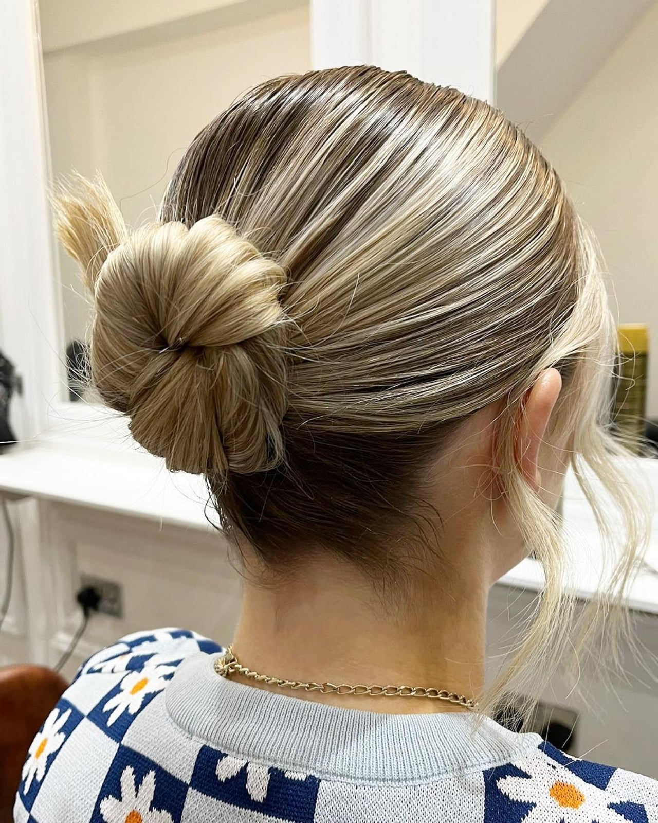 Sleek Blonde Bun With Dark Roots Sleek Blonde Bun With Dark Roots — Trendy Work Hair