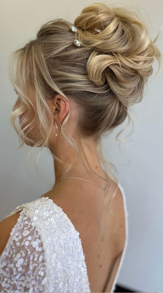 Voluminous Blonde Updo With Wispy Bangs Voluminous Blonde Updo With Wispy Bangs — Wedding Bun Ideas